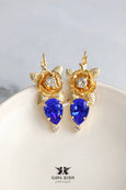 Floral Royal Blue Crystal Drop Earrings feature stunning Austrian crystals. They are perfect for adding a touch of sophistication to any outfit. Ideal for special occasions or everyday glamour, they make a thoughtful gift for someone special.